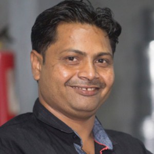 Khalil Ahmed, an Indian man, smiling for the camera.