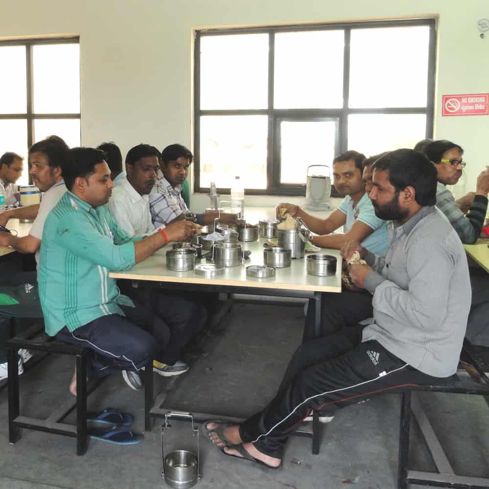 A group of people sitting at a table eating Fair Trade food.