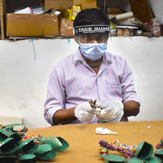 A masked worker faces the COVID challenge in a factory.